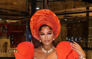 Shine Rosman Glows Like Golden Hour in Fiery Orange & Sculptural Gele